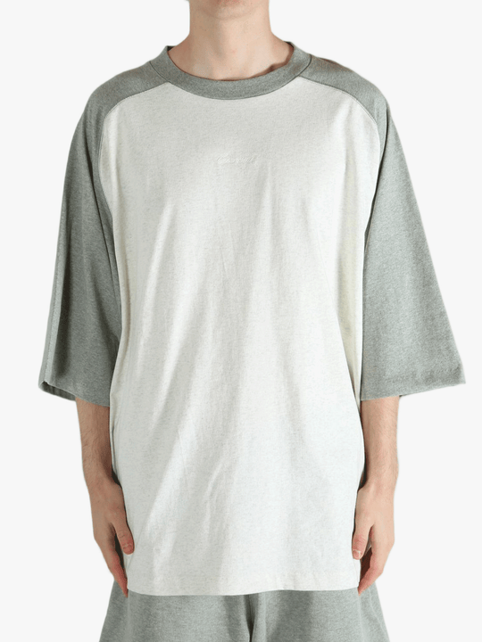 White t-shirt worn by a person, showing the shirt's fit