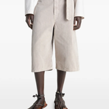 Beige wide-leg pant worn by a person, showing the pants fit