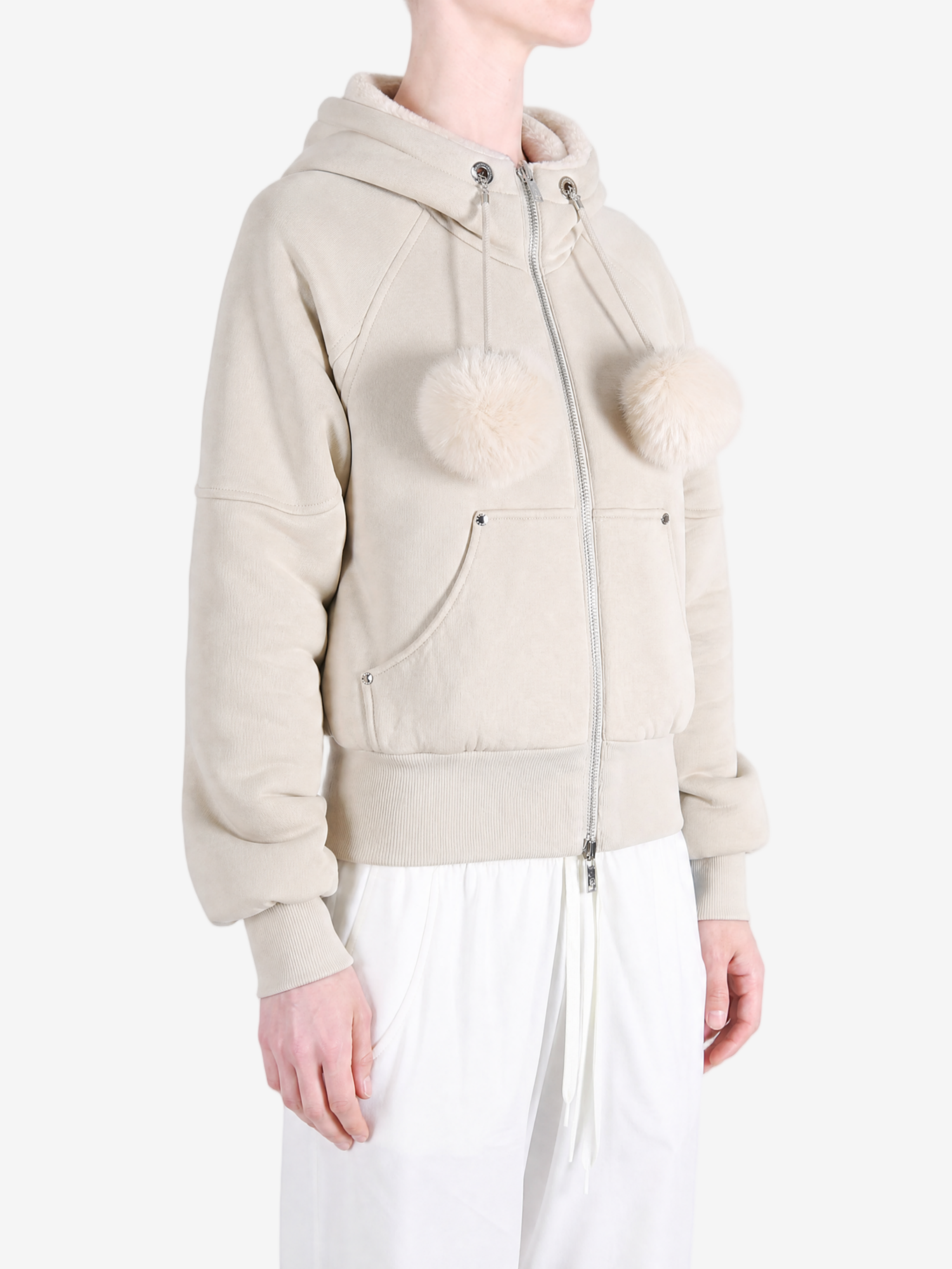 Tan knitwear worn by a person, showing the knitwear fit