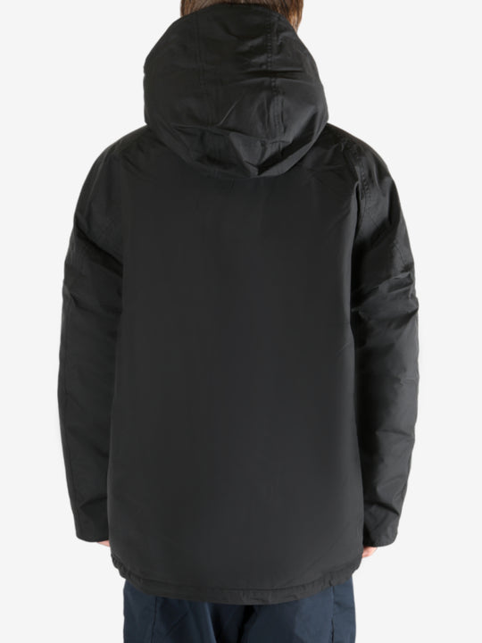 Black coat worn by a person,showing the coat fit