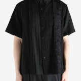 Black shirt worn by a person, showing the shirt's fit