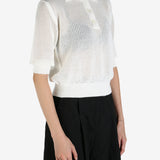 White shirt worn by a person, showing the shirt's fit