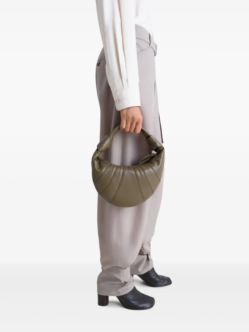 Green bag worn by a person, showing the bag's fit