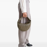 Green bag worn by a person, showing the bag's fit