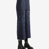Navy pleated pants  worn by a person, showing the pants fit