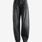 Black jeans worn by a person, showing the jean's fit