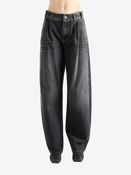 Black jeans worn by a person, showing the jean's fit