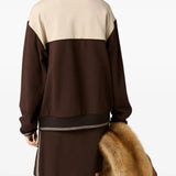 Brown sweatshirt worn by a person, showing the sweatshirt's fit