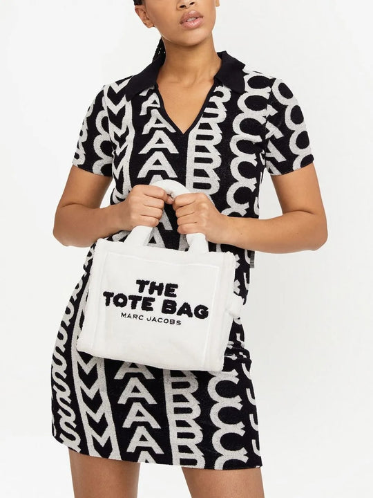 White bag carried by a person, showing the bag's fit