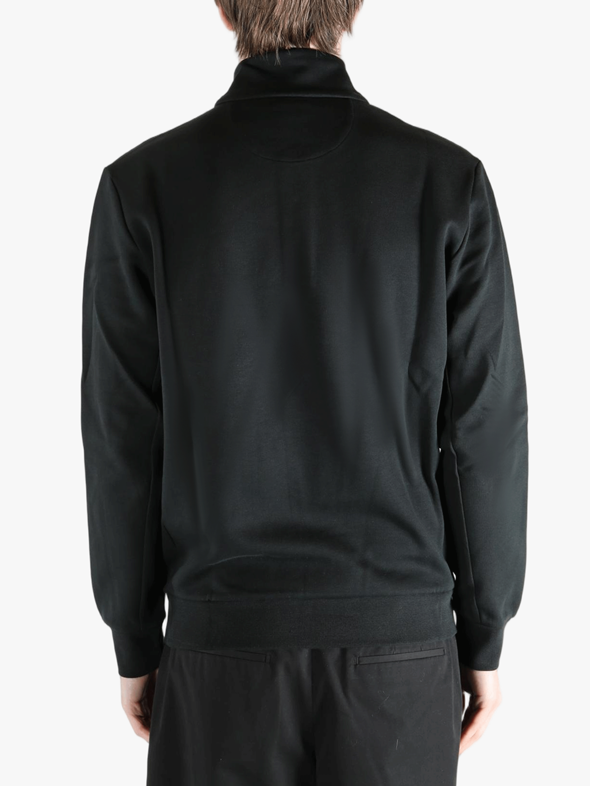 Black pullover worn by a person, showing the pullover's fit