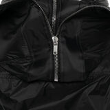 Close up of the black jacket, showing texture of the nylon fabric