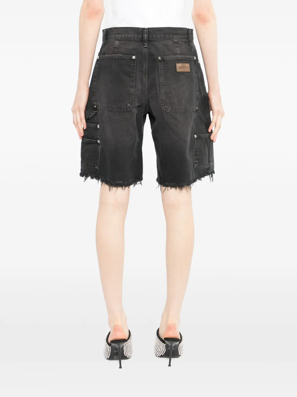 Black short worn by a person, showing the short's fit