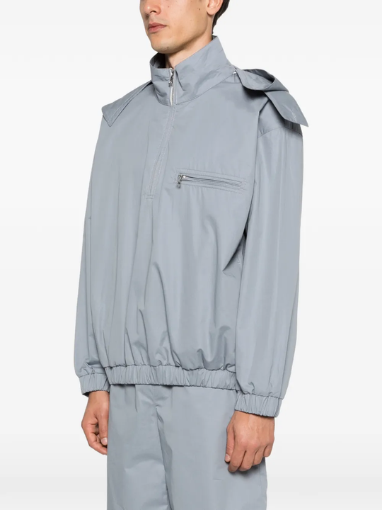 Grey windbreaker worn by a person, showing the windbreaker fit