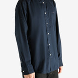 Navy shirt worn by a person, showing the shirt's fit
