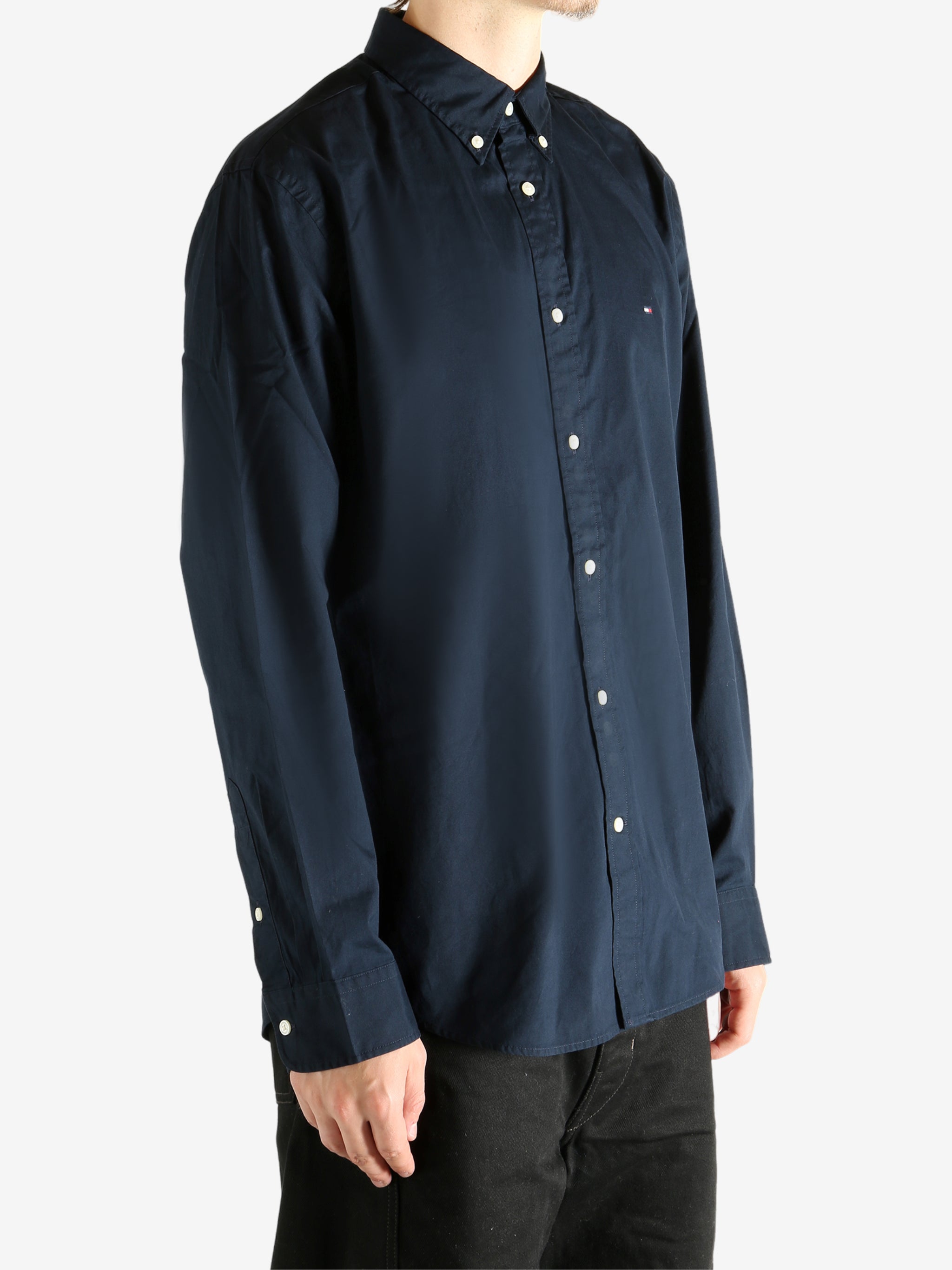 Navy shirt worn by a person, showing the shirt's fit