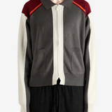 Grey knitwear worn by a person, showing the knitwear fit