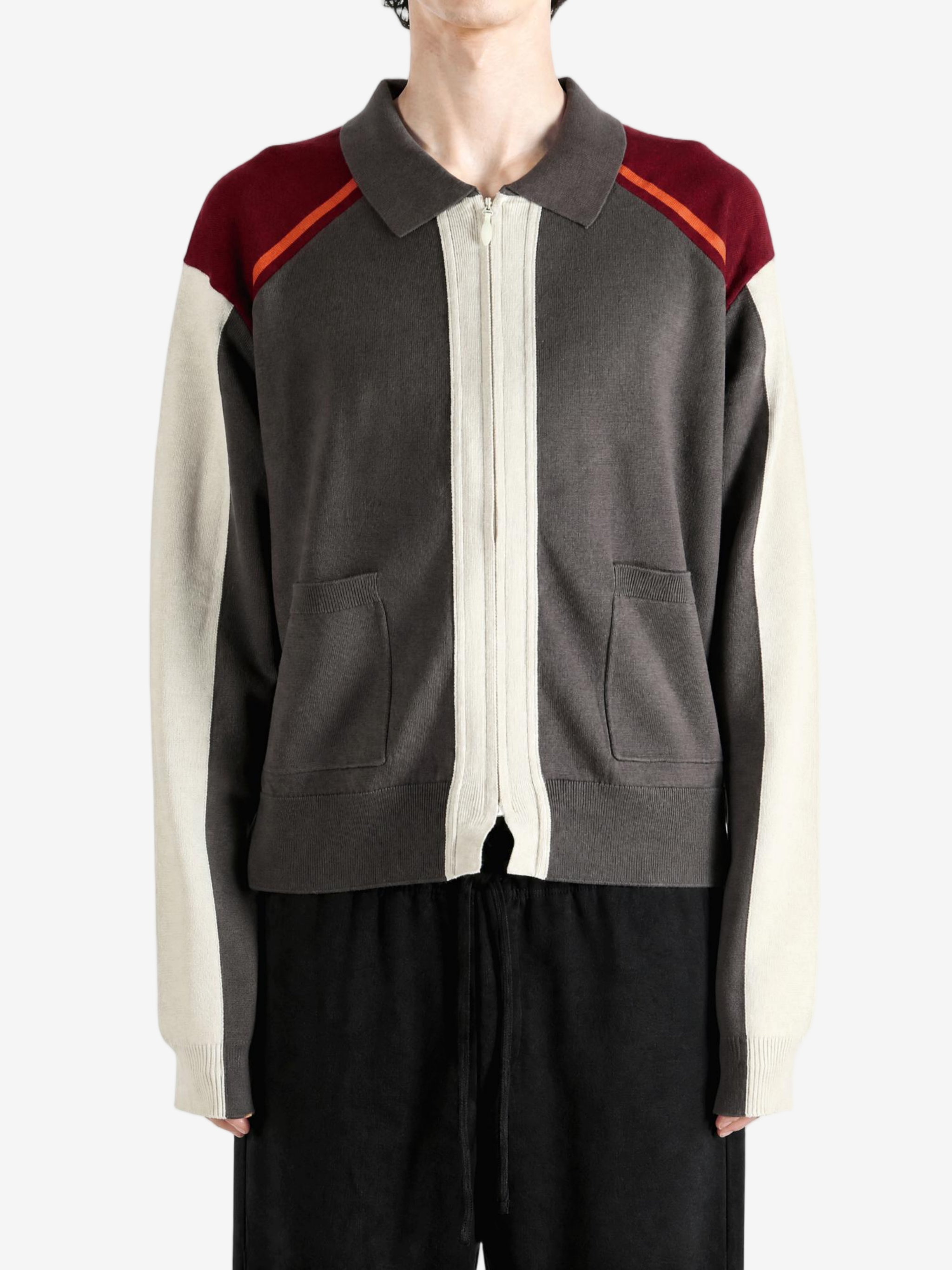 Grey knitwear worn by a person, showing the knitwear fit
