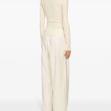 White top worn by a person, showing the top's fit