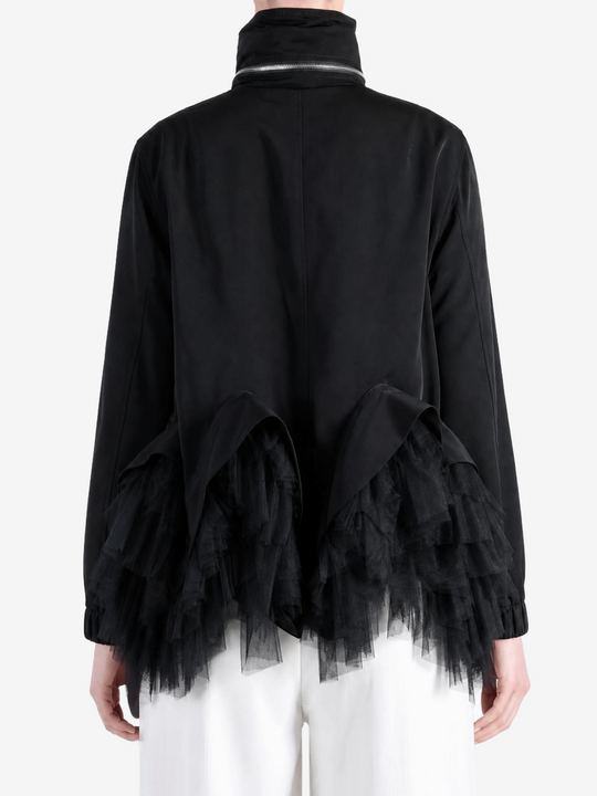 Black jacket worn by a person, showing the jacket fit