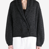 Black knitwear worn by a person, showing the knitwear fit