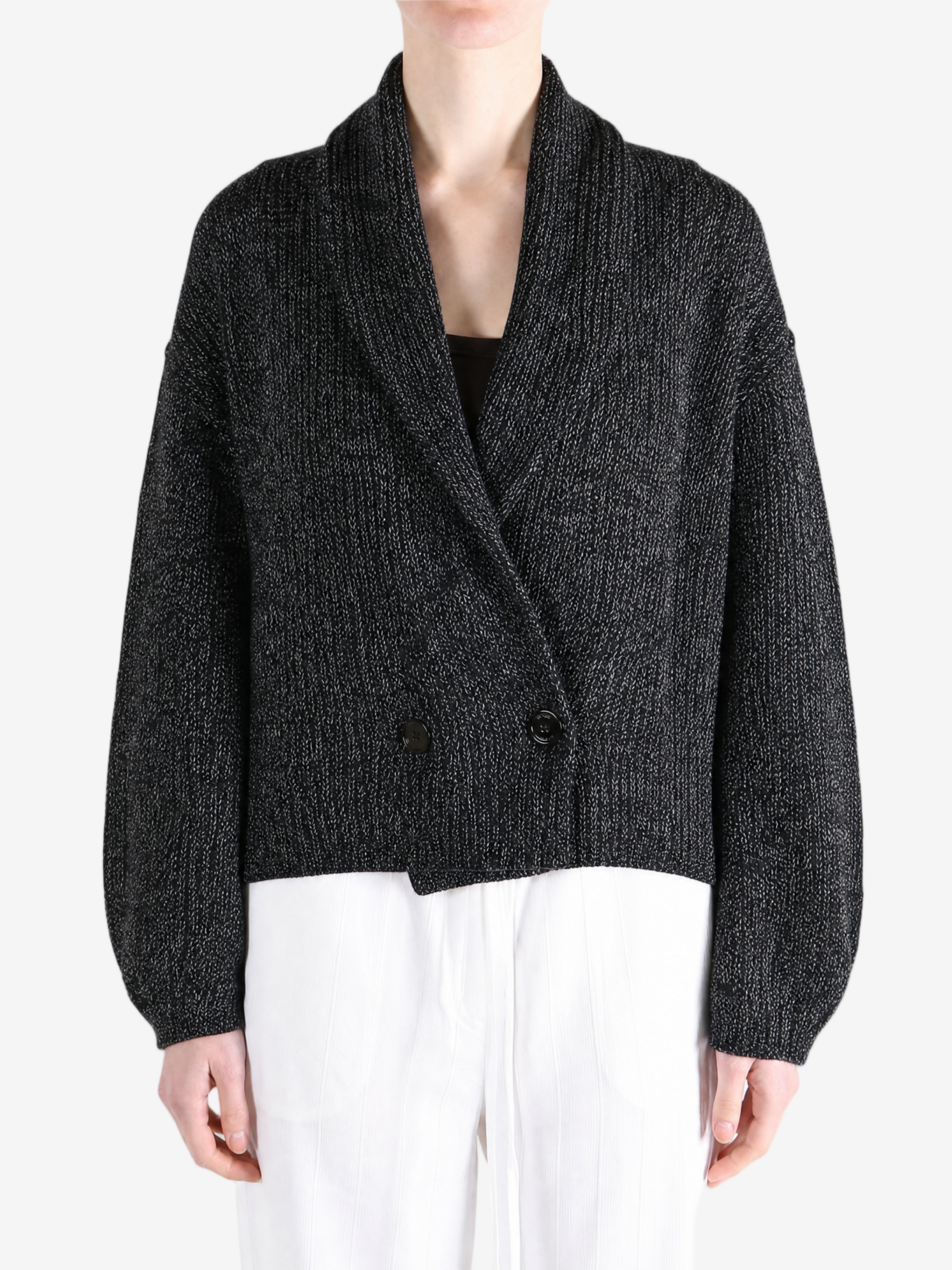 Black knitwear worn by a person, showing the knitwear fit