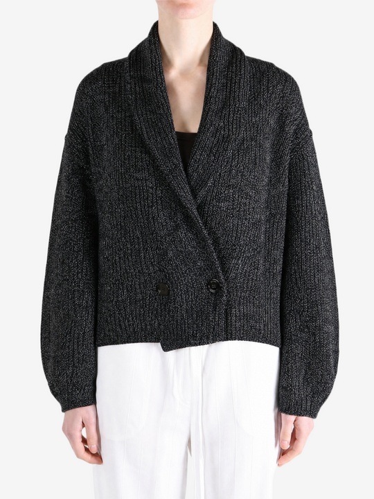 Black knitwear worn by a person, showing the knitwear fit