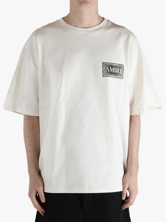 White t-shirt worn by a person, showing the t-shirt's fit