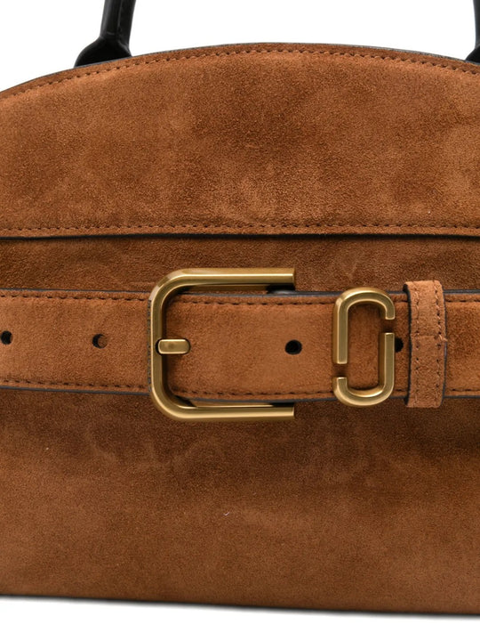 Close up of brown bags, showing texture of the suede cow leather fabric