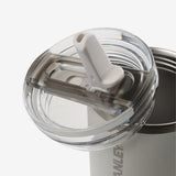 Close up of tan tumbler, showing texture of the lid and straw