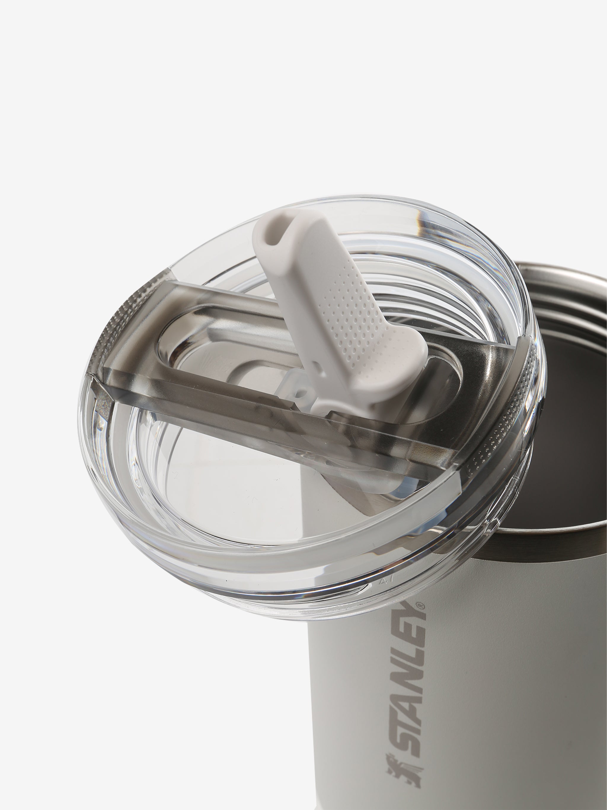 Close up of tan tumbler, showing texture of the lid and straw