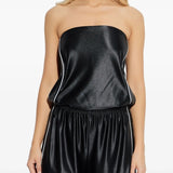 Black tops worn by a person, showing the tops fit