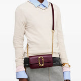 Burgundy accessories worn by a person, showing the accessories fit