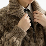 Brown knitwear worn by a person, showing the knitwear fit