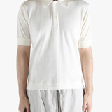 White top worn by a person, showing the top's fit