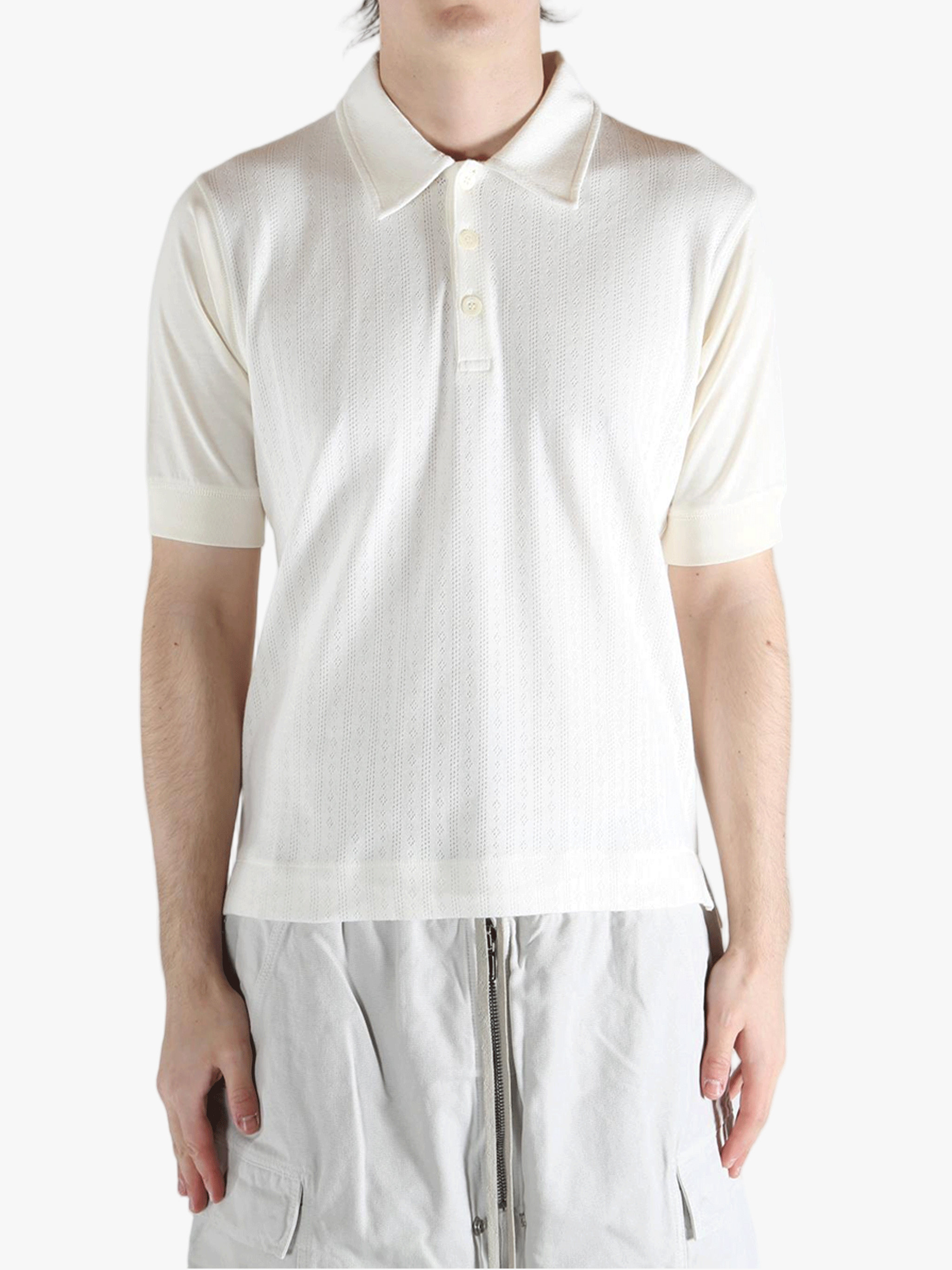 White top worn by a person, showing the top's fit