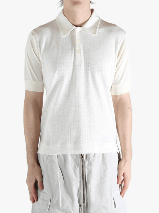 White top worn by a person, showing the top's fit