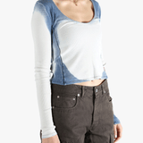 White long sleeve worn by a person, showing the tight fit.