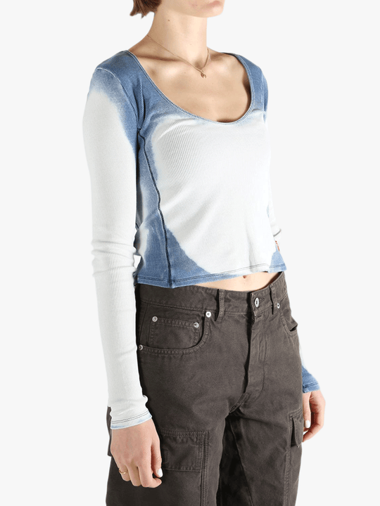 White long sleeve worn by a person, showing the tight fit.