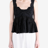 Black top worn by a person, showing the top fit