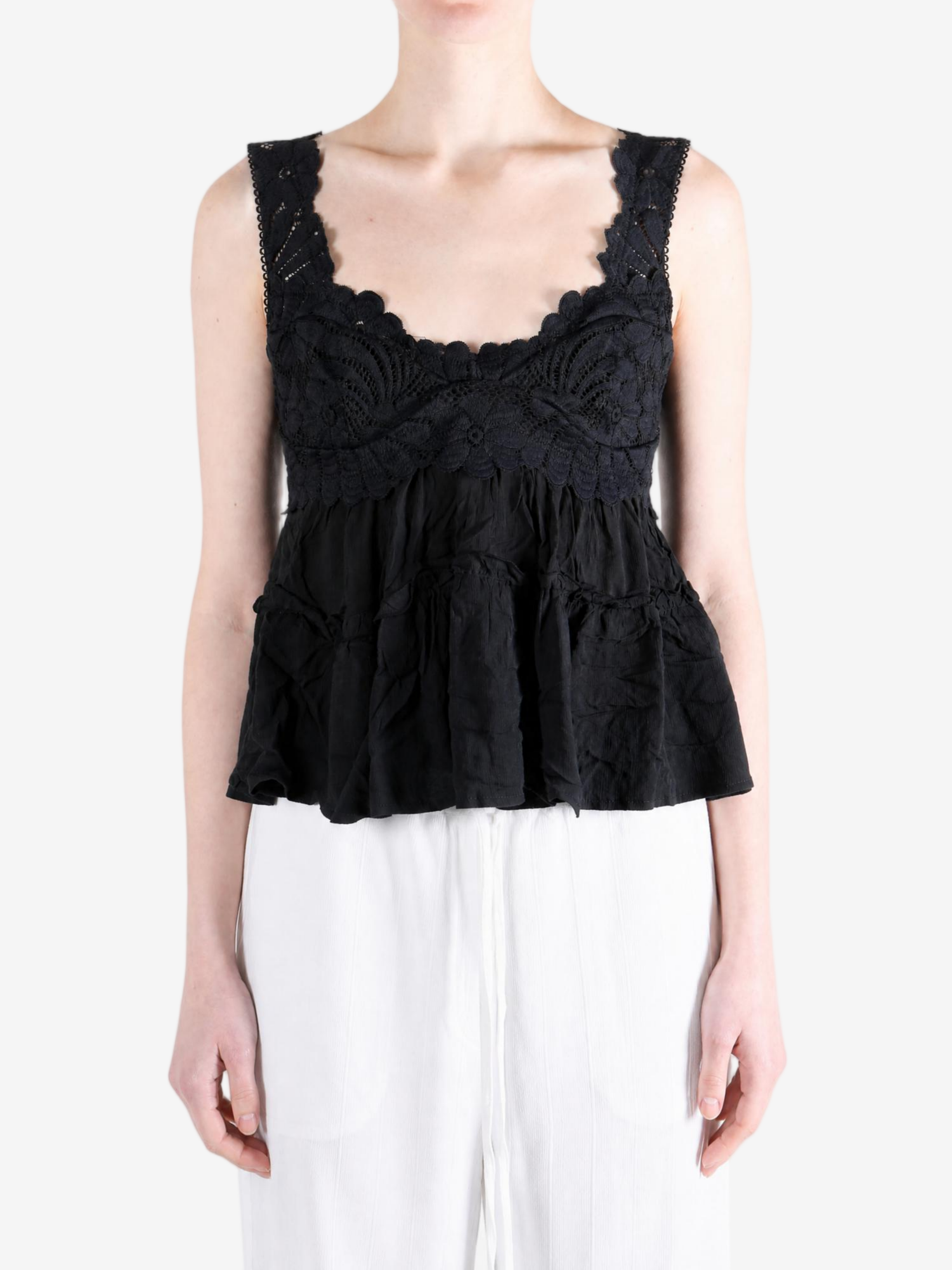 Black top worn by a person, showing the top fit