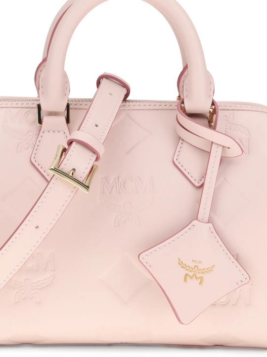 Close up of pink bag, showing texture of the leather fabric