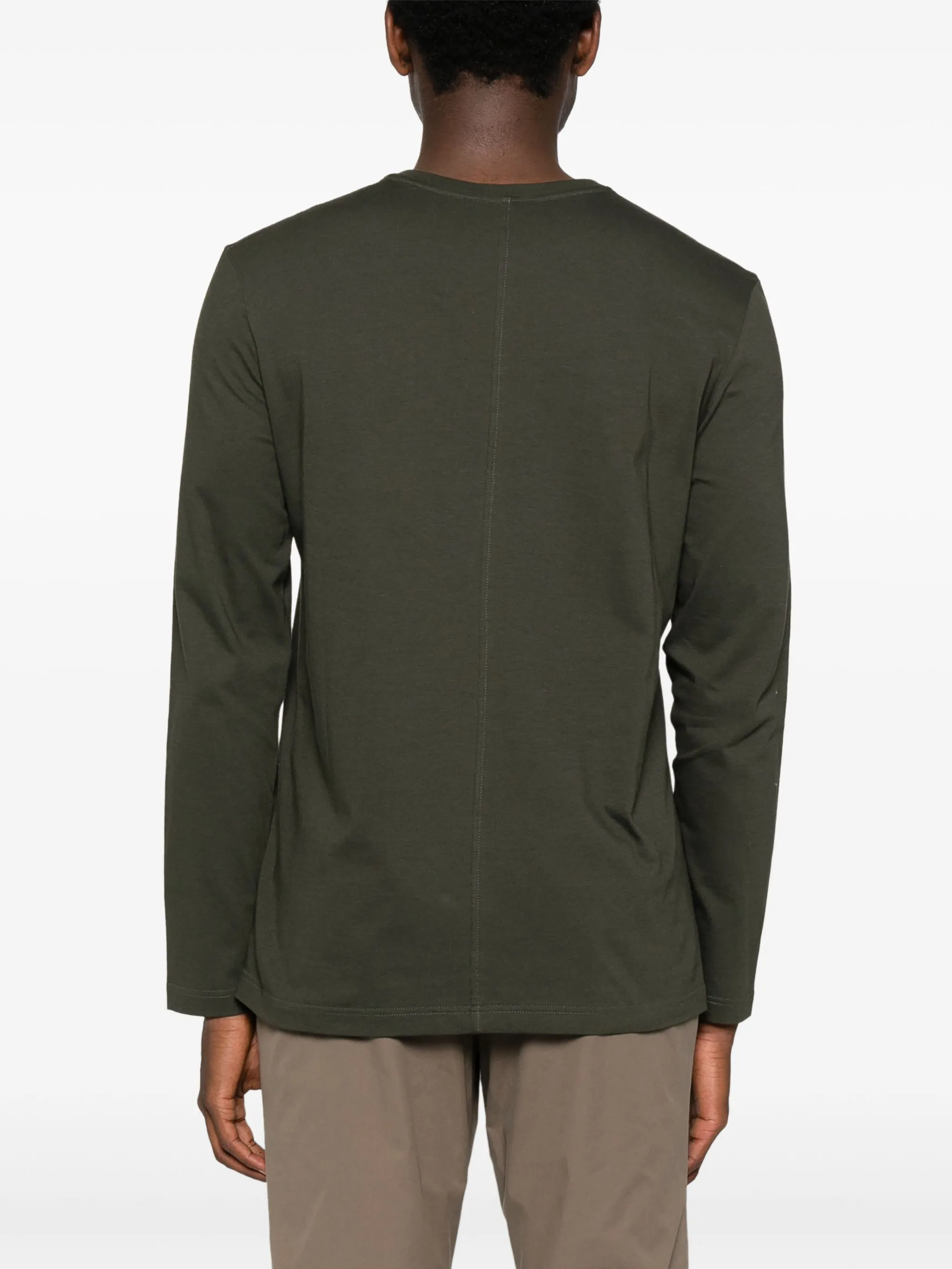 Green t-shirt worn by a person, showing the t-shirt fit