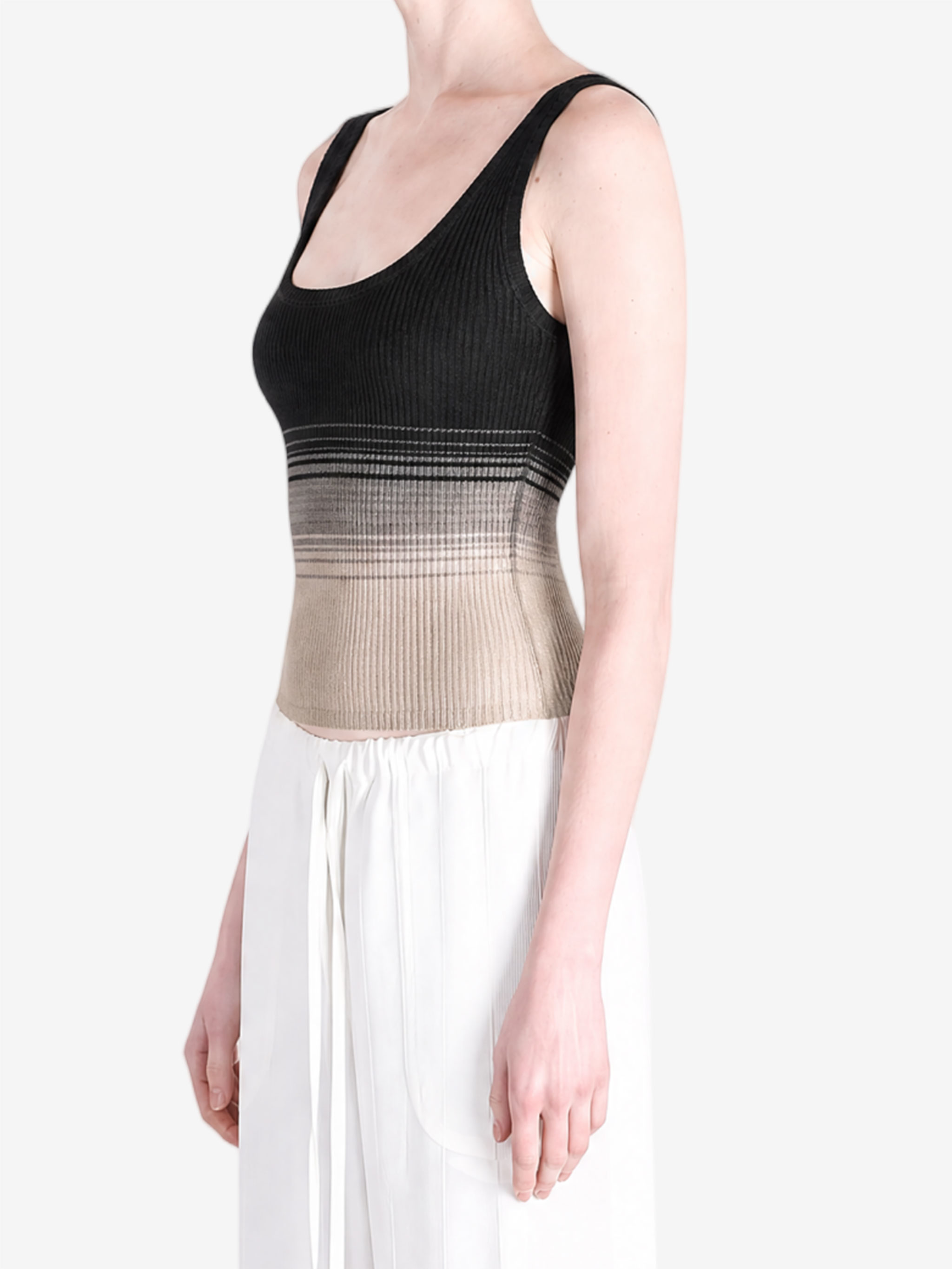 Black tops worn a person,showing the tops fit