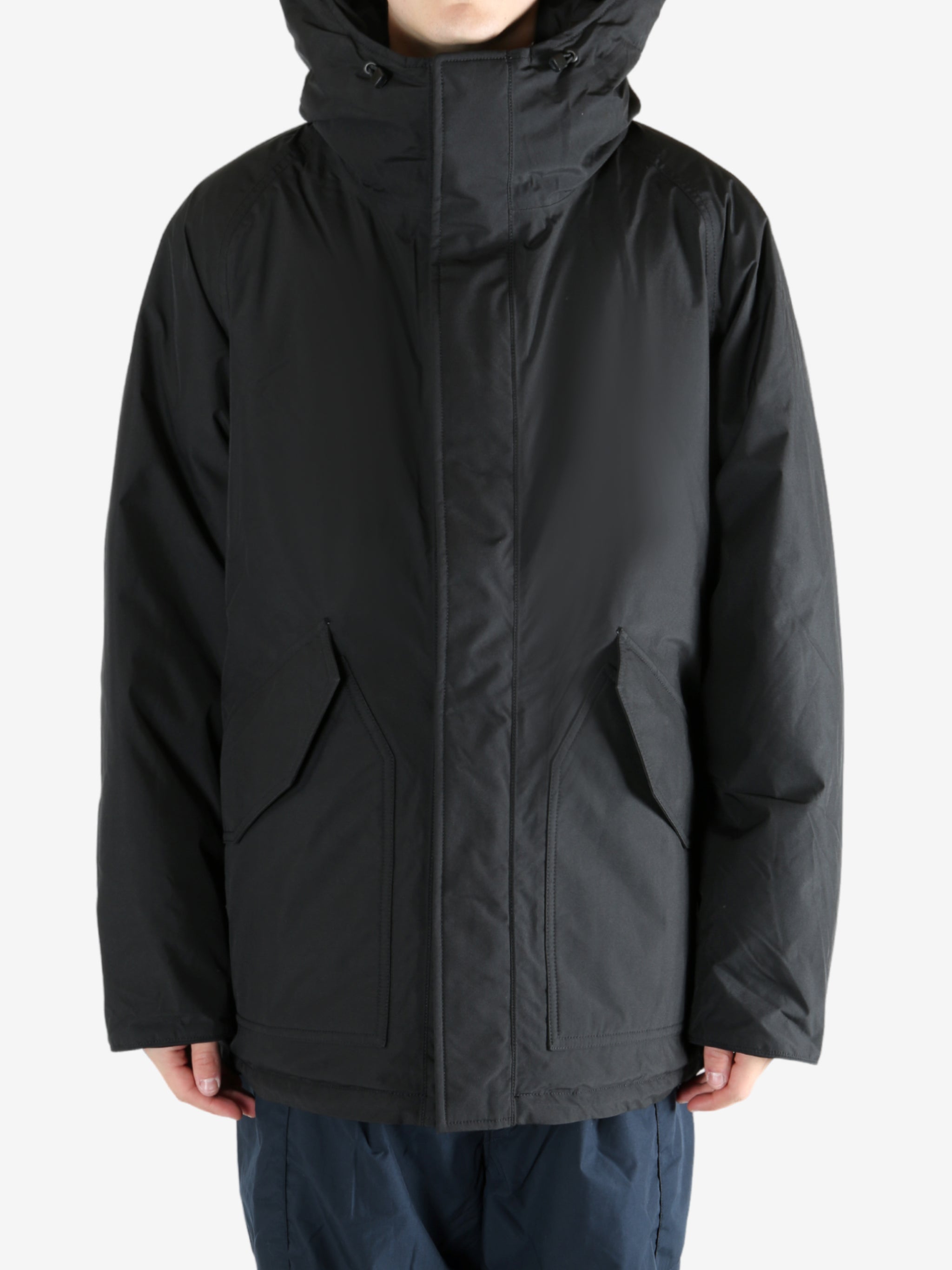 Black coat worn by a person,showing the coat fit