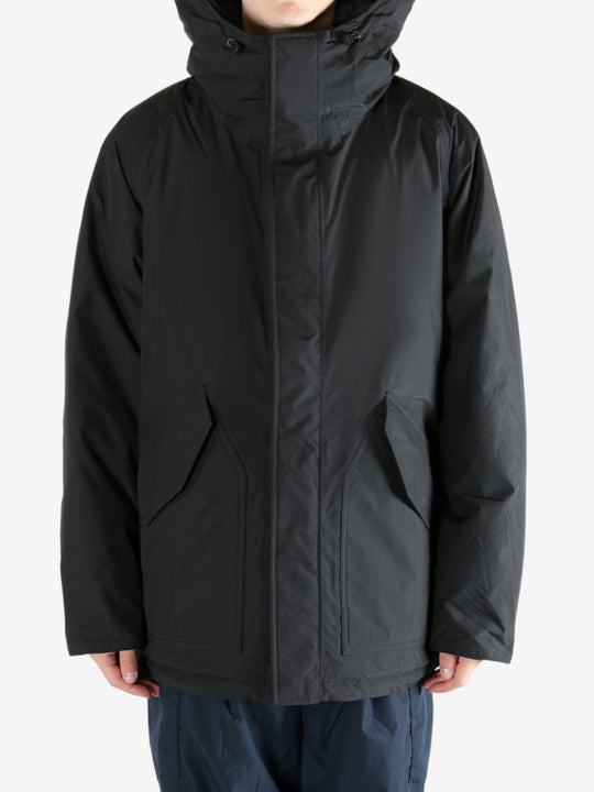 Black coat worn by a person,showing the coat fit