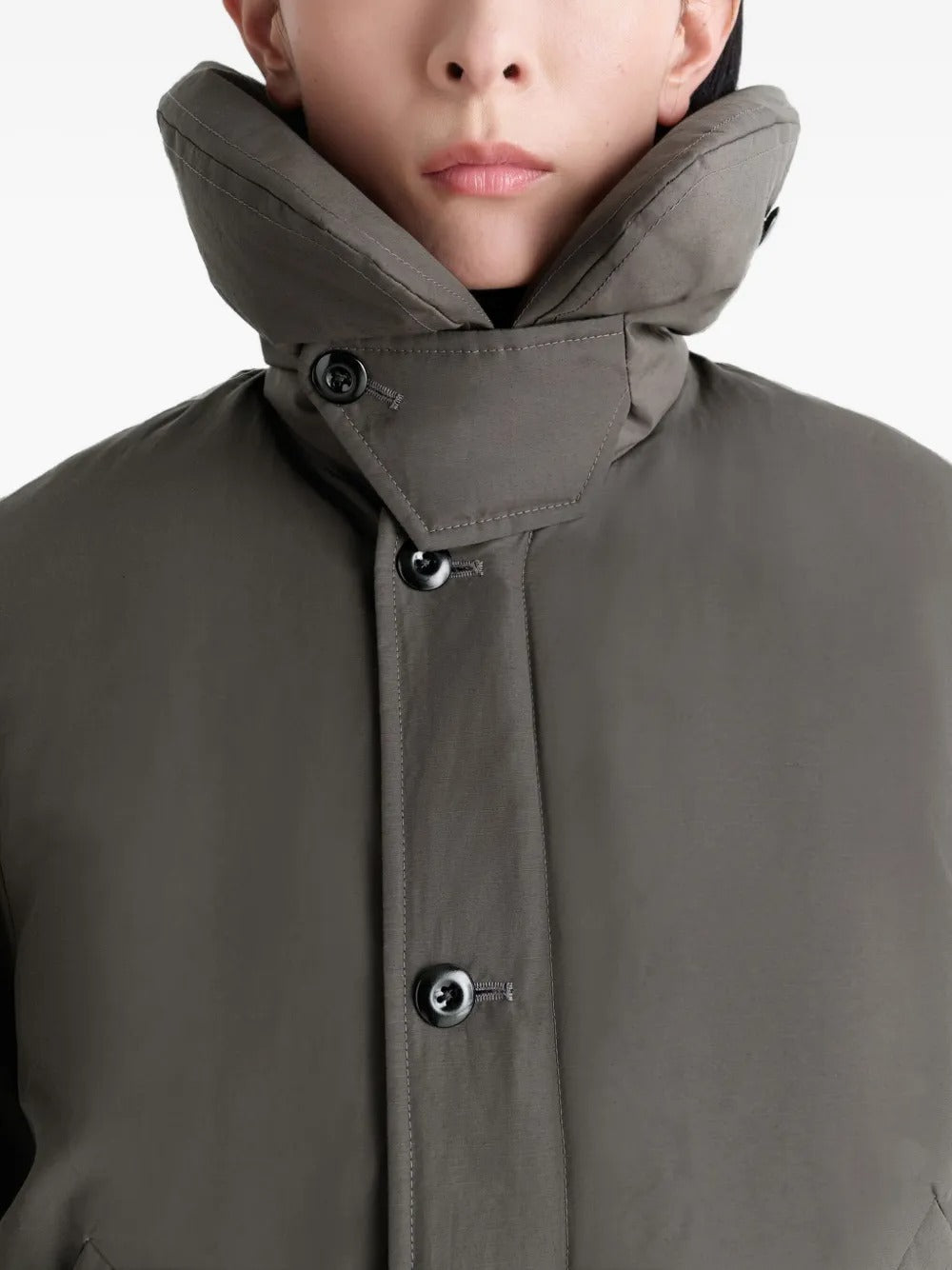 Close up of grey coat, showing texture of the polyamide fabric
