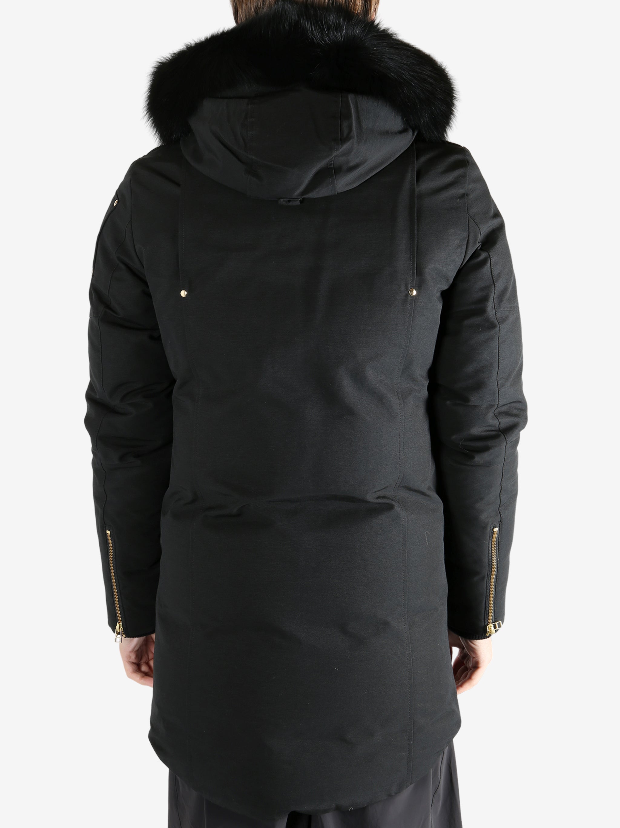 Black coat worn by a person, showing the coat's fit