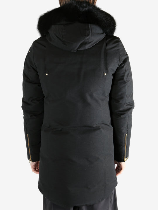 Black coat worn by a person, showing the coat's fit