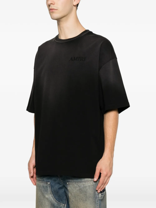 Black t-shirt worn by a person, showing the t-shirt's fit