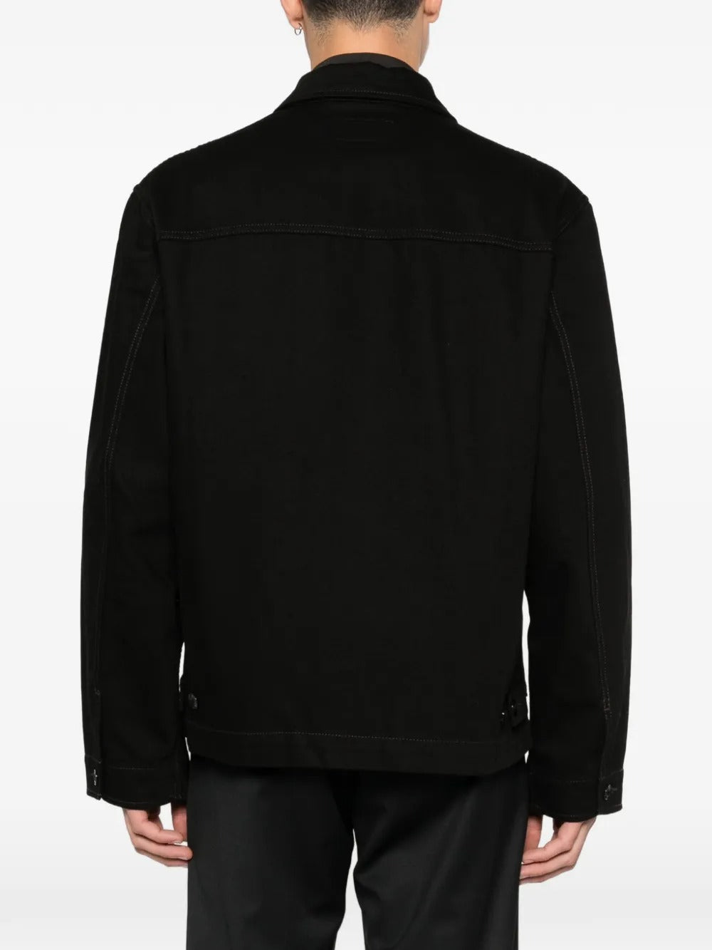 Black jacket worn by a person, showing the jacket fit